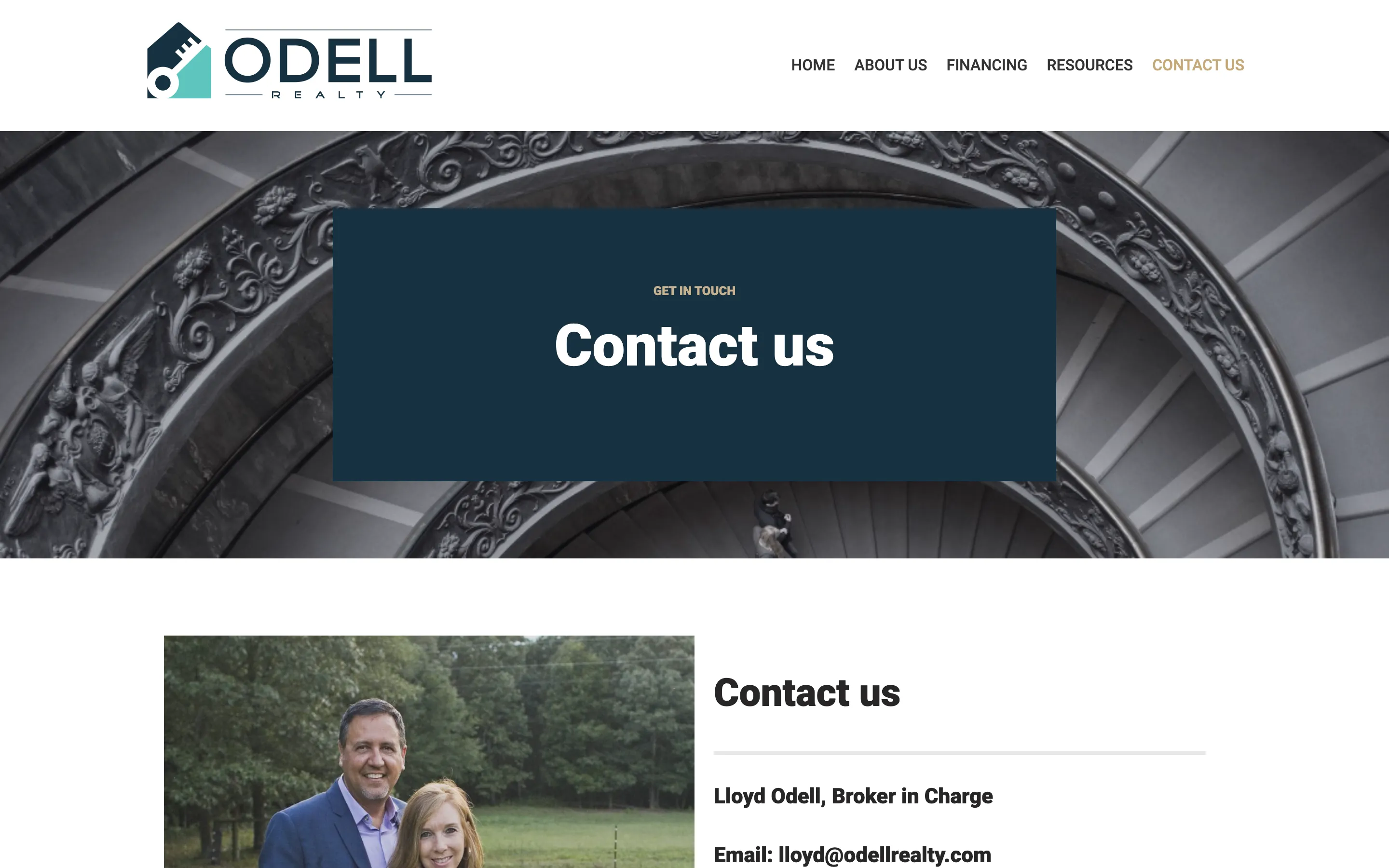 The previous Odell Realty contact page: a stock photograph of a marble spiral staircase behind a blue box reading "Contact us".